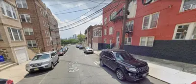 a city street with cars parked on the street at Apart Studio West NY 12Mints From NYCity Times Square in West New York