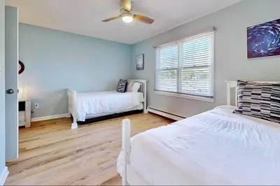 a bedroom with two beds and a window at Charming 3 bedroom Beach Front Cottage in Milford
