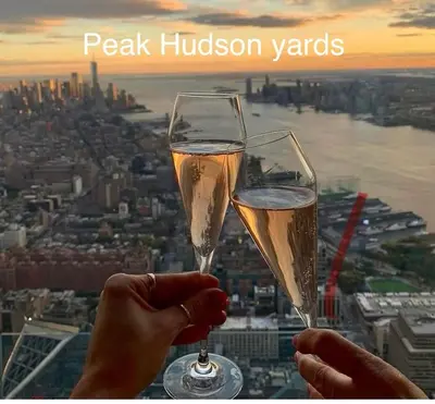 two people holding glasses of champagne in front of a city at Private Room A-KING BED-12Mints NYCity Times Square in West New York
