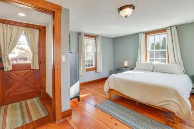 a bedroom with a bed and a wooden door at Walk to Memorial Park Pet-Friendly Bethlehem Home in Bethlehem