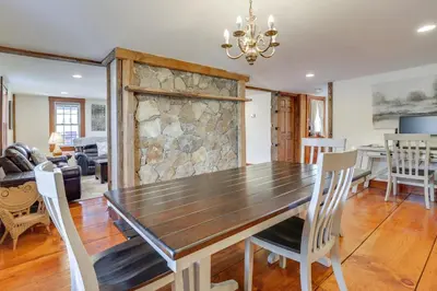 a dining room and living room with a wooden table and chairs at Walk to Memorial Park Pet-Friendly Bethlehem Home in Bethlehem