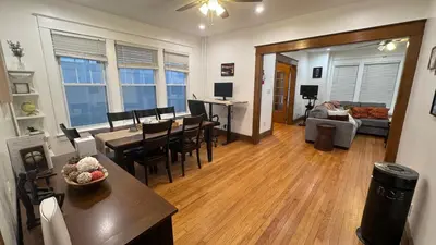 a living room with a table and chairs and a couch at Modern and Cozy Pine Hills Home from Early 1900s in Albany