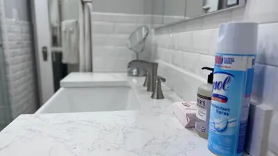 a bathroom counter with a sink and a bottle of toothpaste at Modern and Cozy Pine Hills Home from Early 1900s in Albany