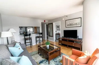 a living room with a couch and a tv at Spacious Apt Downtown in Stamford