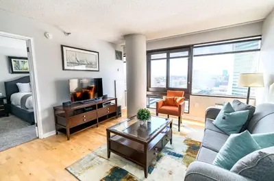 a living room with a couch and a tv at Spacious Apt Downtown in Stamford