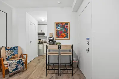 a kitchen with a table and a chair in a room at Highly Recommended Studio Near Times Square in New York