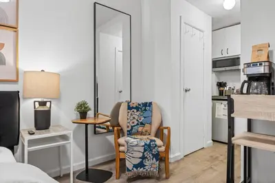 a living room with a chair and a table at Highly Recommended Studio Near Times Square in New York