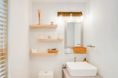 a bathroom with a white sink and a mirror at Lakefront Hinsdale Home about 10 Mi to Pittsfield! in Hinsdale