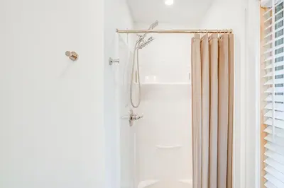 a bathroom with a shower with a shower curtain at Lakefront Hinsdale Home about 10 Mi to Pittsfield! in Hinsdale