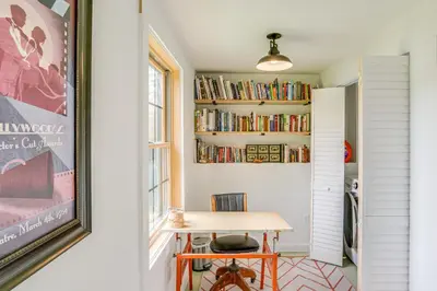 a room with a table and bookshelves at Lakefront Hinsdale Home about 10 Mi to Pittsfield! in Hinsdale