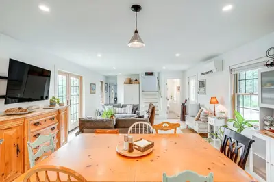 a kitchen and living room with a wooden table at Lakefront Hinsdale Home about 10 Mi to Pittsfield! in Hinsdale