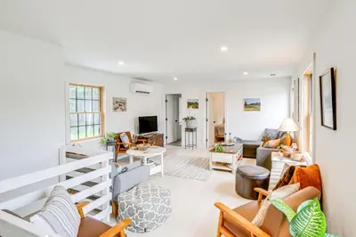 a living room with white walls and furniture at Lakefront Hinsdale Home about 10 Mi to Pittsfield! in Hinsdale