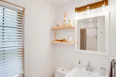 a bathroom with a sink and a mirror at Lakefront Hinsdale Home about 10 Mi to Pittsfield! in Hinsdale