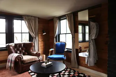 a living room with a couch and a chair and a table at KIngston Carriage House in Kingston