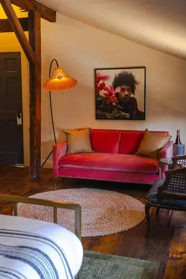 a red couch in a living room with a lamp at KIngston Carriage House in Kingston