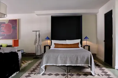 a bedroom with a bed with a large black headboard at KIngston Carriage House in Kingston