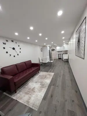 a living room with a brown couch in a room at Extended Family Stay in Passaic