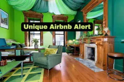 a living room with green walls and a fireplace at The Green Room: 70s Groove Themed Studio in New York