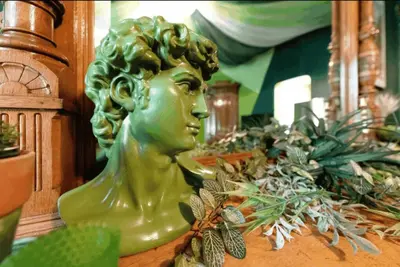 a green statue of a woman sitting on a table at The Green Room: 70s Groove Themed Studio in New York