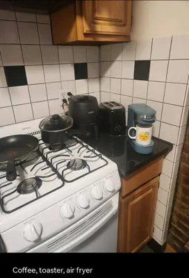 a kitchen with a stove with pots and pans on it at Conveniently located in the heart of the city in New York
