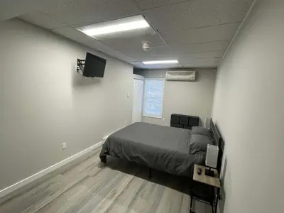 a bedroom with a bed and a flat screen tv at Private Apartment in Southbury 102 in Southbury