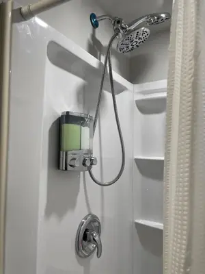 a shower with a shower head in a bathroom at Private Apartment in Southbury 102 in Southbury