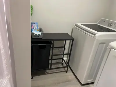 a small black table next to a small refrigerator at Private Apartment in Southbury 102 in Southbury