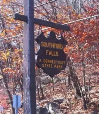 a street sign on a pole next to a fence at Private Apartment in Southbury 102 in Southbury