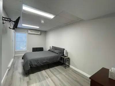 a bedroom with a bed and a television in it at Private Apartment in Southbury 102 in Southbury