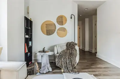 a living room with a bear sitting on a chair at Luxurious 1BR Downtown Stamford in Stamford