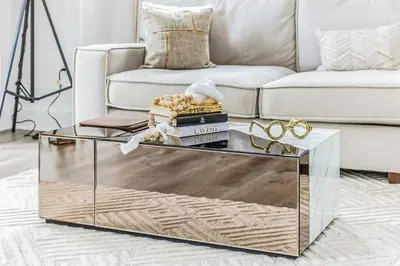 a living room with a glass coffee table in front of a couch at Luxurious 1BR Downtown Stamford in Stamford