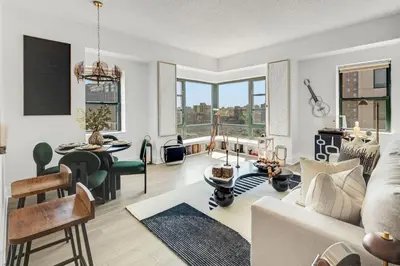 a living room with a couch and a table at Penthouse Perfection with Unmatched Skyline Views in Stamford