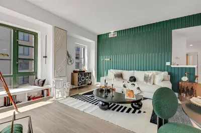 a living room with a couch and a table at Penthouse Perfection with Unmatched Skyline Views in Stamford