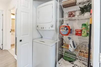 a refrigerator with its door open with food inside at Penthouse Perfection with Unmatched Skyline Views in Stamford