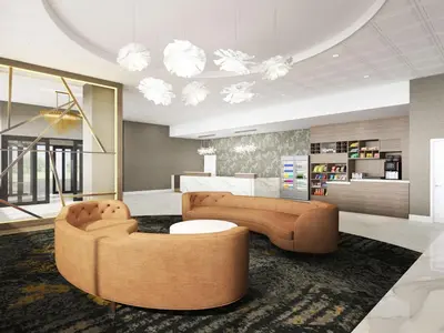 a living room with two couches and a table at DoubleTree by Hilton Poughkeepsie in Poughkeepsie