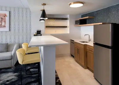 a kitchen with a counter and a refrigerator at DoubleTree by Hilton Poughkeepsie in Poughkeepsie