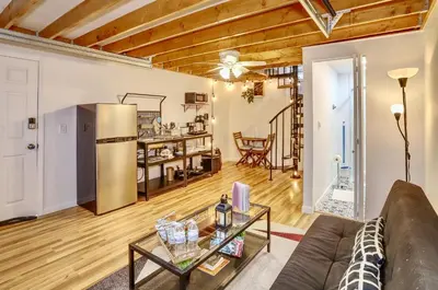 a living room with a couch and a table at NYC Loft Studio Near MetLife World Cup Stadium & Times Square in North Bergen
