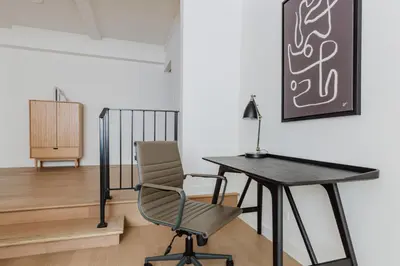 a desk and a chair in a room at Blueground UES elev wd nr Museum Mile NYC-1530 in New York