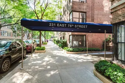 a sidewalk with a blue awning on a street at Blueground UES elev wd nr Museum Mile NYC-1530 in New York