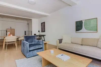 a living room with a couch and a table at Blueground UES elev wd nr Museum Mile NYC-1530 in New York