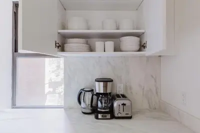 a kitchen with a coffee maker and a blender at Blueground UES elev wd nr Museum Mile NYC-1530 in New York