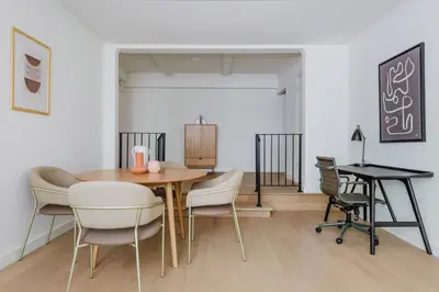 a dining room with a table and chairs at Blueground UES elev wd nr Museum Mile NYC-1530 in New York