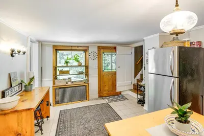 a kitchen with a refrigerator and a table at Historic Catskills Farmhouse Ski, Hike and Relax! in Catskill