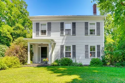 a white house with a porch and a grass yard at Historic Catskills Farmhouse Ski, Hike and Relax! in Catskill