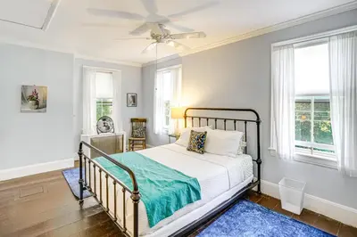 a bedroom with a bed and a ceiling fan at Historic Catskills Farmhouse Ski, Hike and Relax! in Catskill