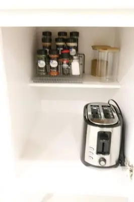 a toaster sitting on a shelf in a kitchen at Luxury king bed parking & washer in Schenectady