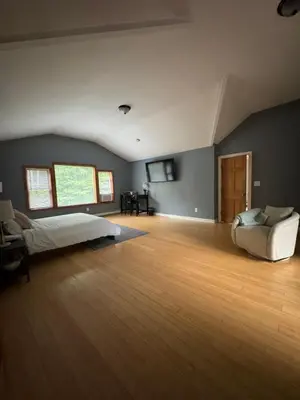 a bedroom with a bed and a couch and a chair at Quiet Cozy Stay Spacious Home Near Beach & Shops in Hamden