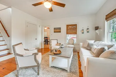 a living room with a white couch and a table at Historic Farmhouse Near Mountains and Colleges! in Westfield