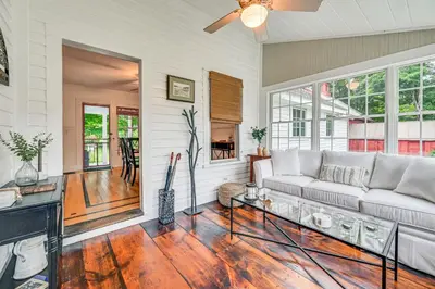 a living room with a couch and a table at Historic Farmhouse Near Mountains and Colleges! in Westfield