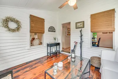 a living room with white walls and a glass table at Historic Farmhouse Near Mountains and Colleges! in Westfield